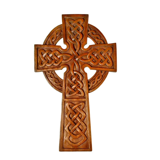 A wooden carving of a Celtic cross with intricate knot work.