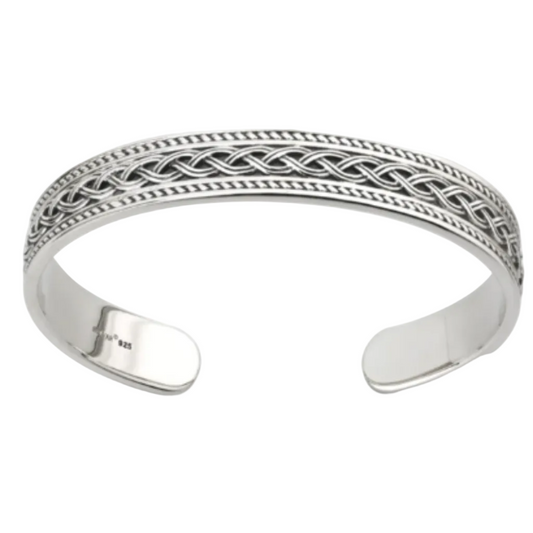 A sterling silver Celtic Knot bangle with intricate patterns, displayed against a white background.