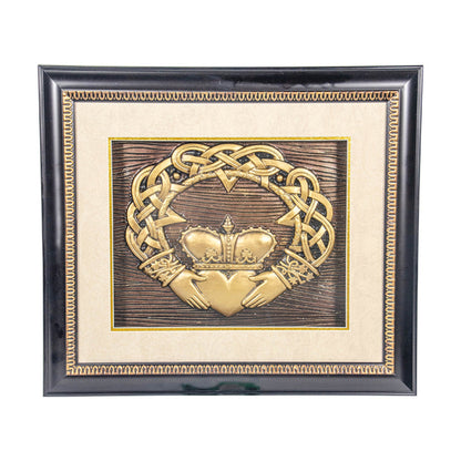 Decorative plaque with Claddagh design and crown in a black frame on a white background