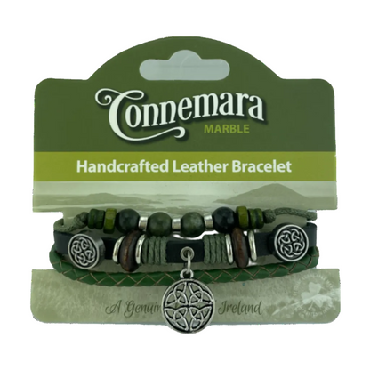 Layered green leather bracelet with various beads and a dangling silver-colored celtic knot charm.