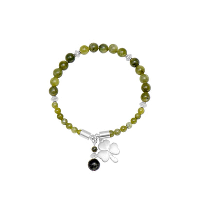 Beaded bracelet with a clover charm on a white background