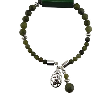 Green Connemara marble bracelet with silver charm on a green Connemara Marble branded card.