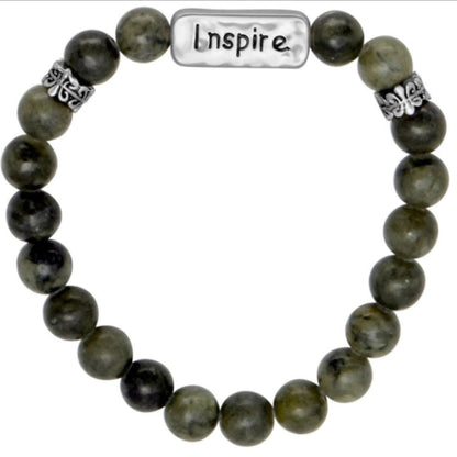 Green beaded bracelet with a charm that says "inspire"