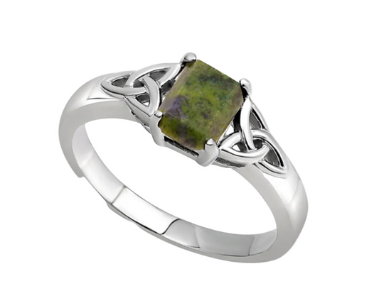 A sterling silver ring with a trinity knot design featuring Connemara marble as the central stone.