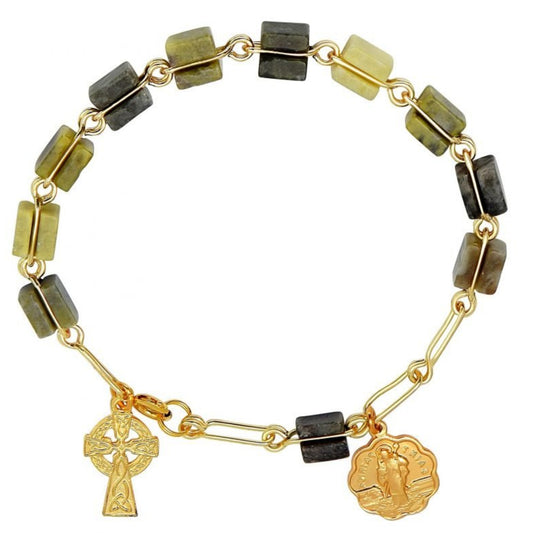 Bracelet with gold chain, green and brown beads, and two charms on a white background