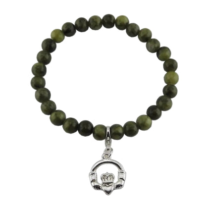 Green beaded bracelet with a silver claddagh charm on a white background