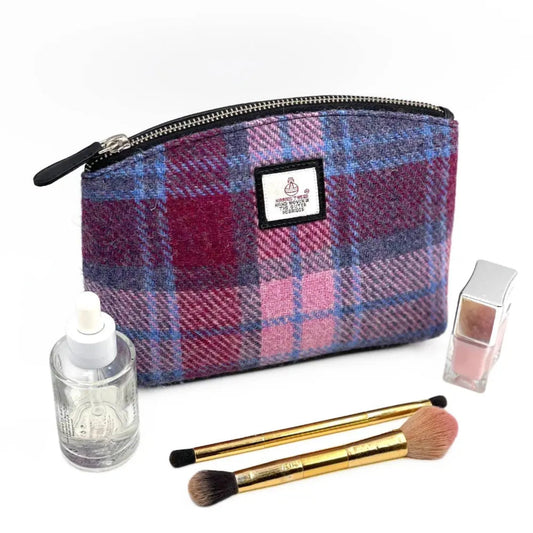 Plaid makeup bag with cosmetic items on a white background