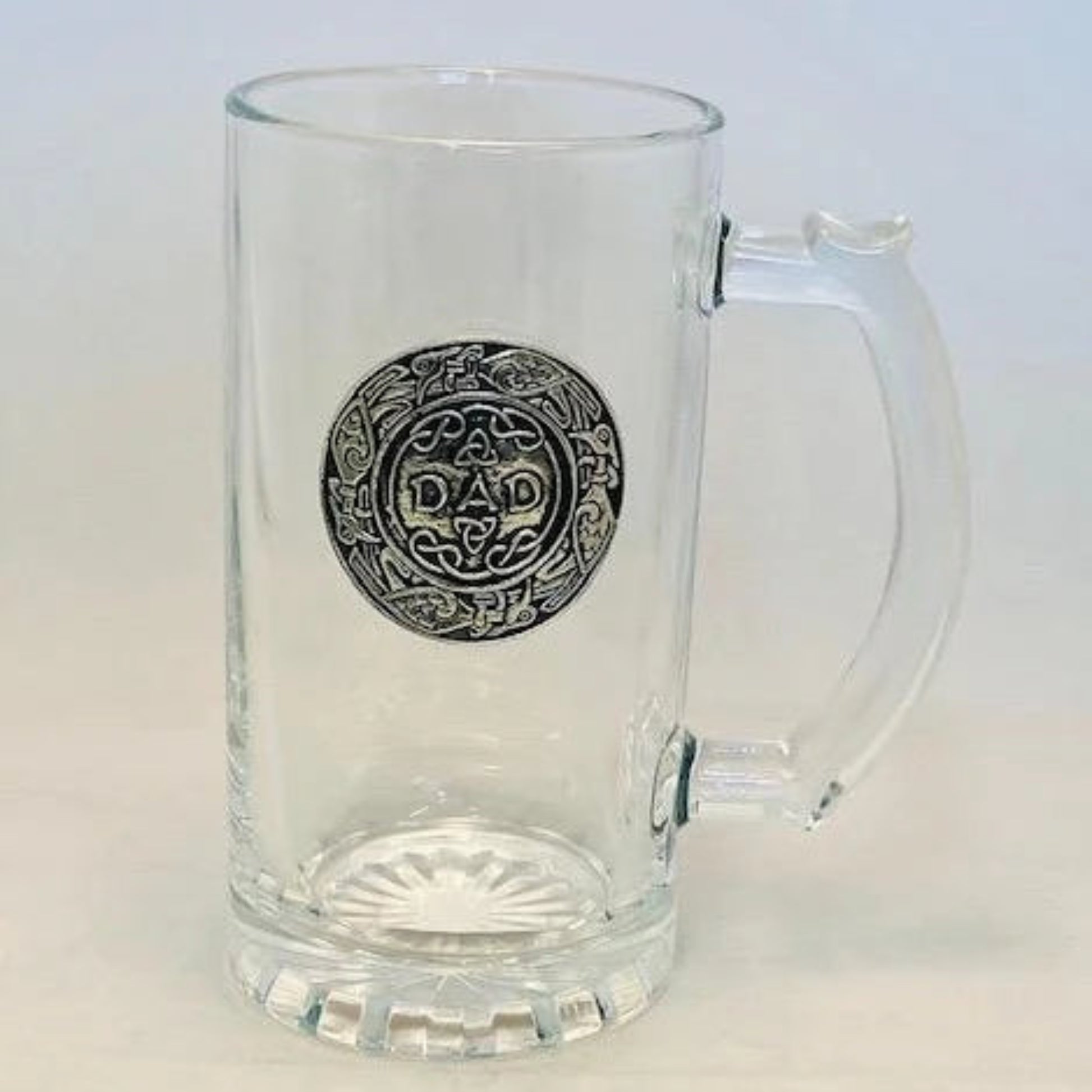 A set of clear glass beer tankards with pewter detailing, displayed on a table with autumnal decorations.