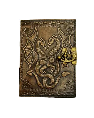 Decorative leather-bound book with embossed dragon design on a white background