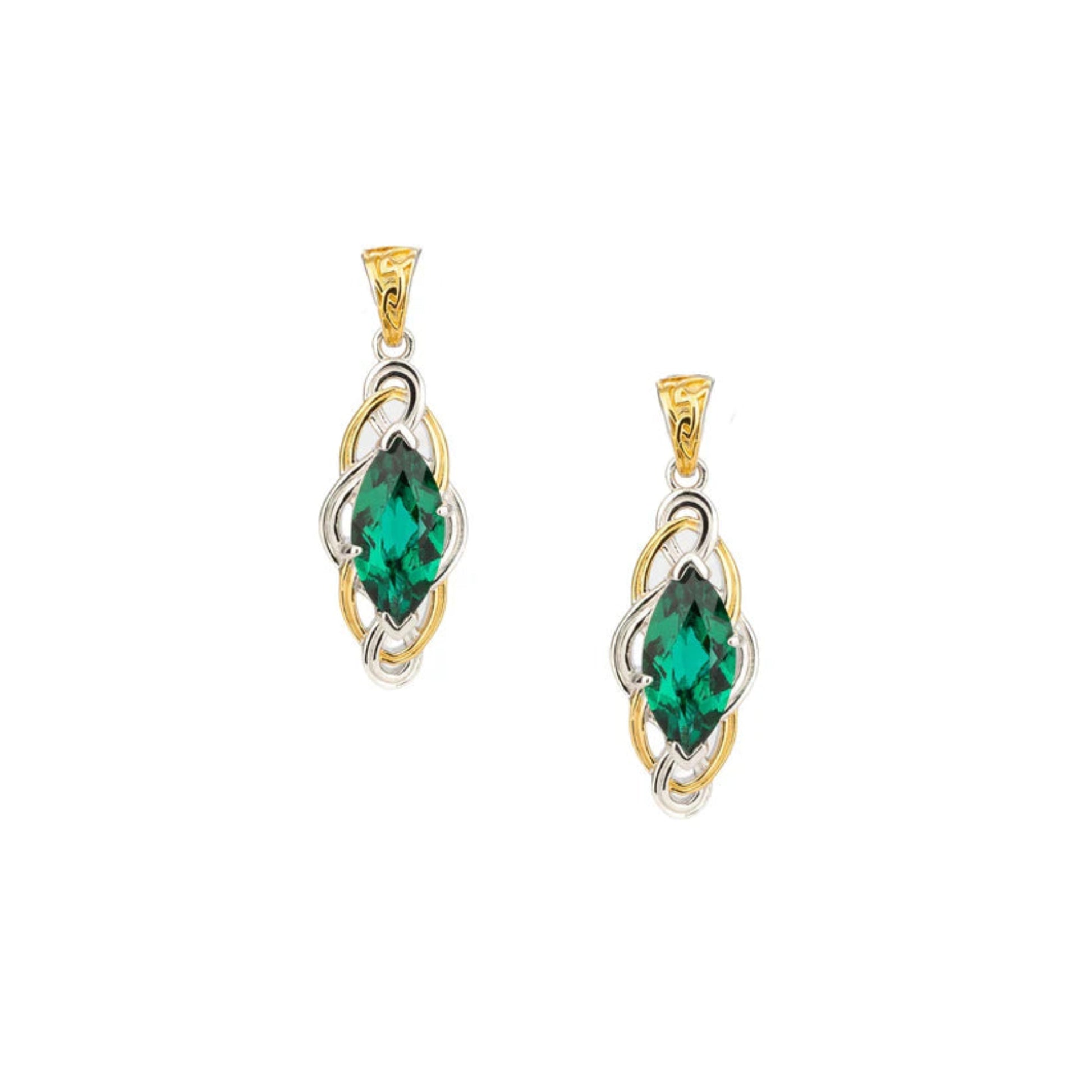 Gold and silver pendant with green gemstone on a white background