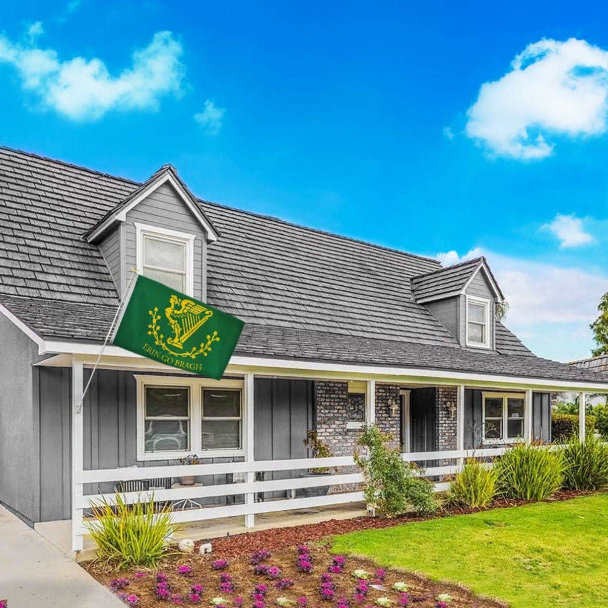 Gray house flying an Erin go Bragh flag off the porch.