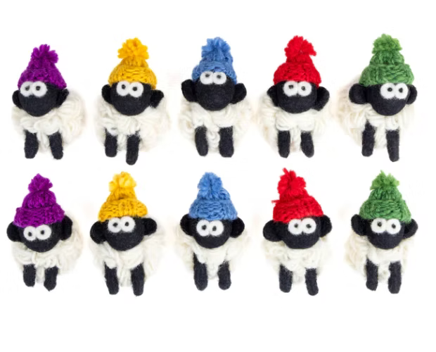 Ten small sheep magnets with knit bobble hats in various colors.