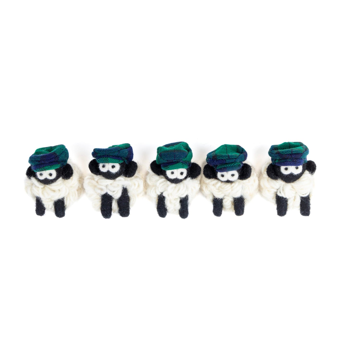 Five small knit sheep with green flat caps
