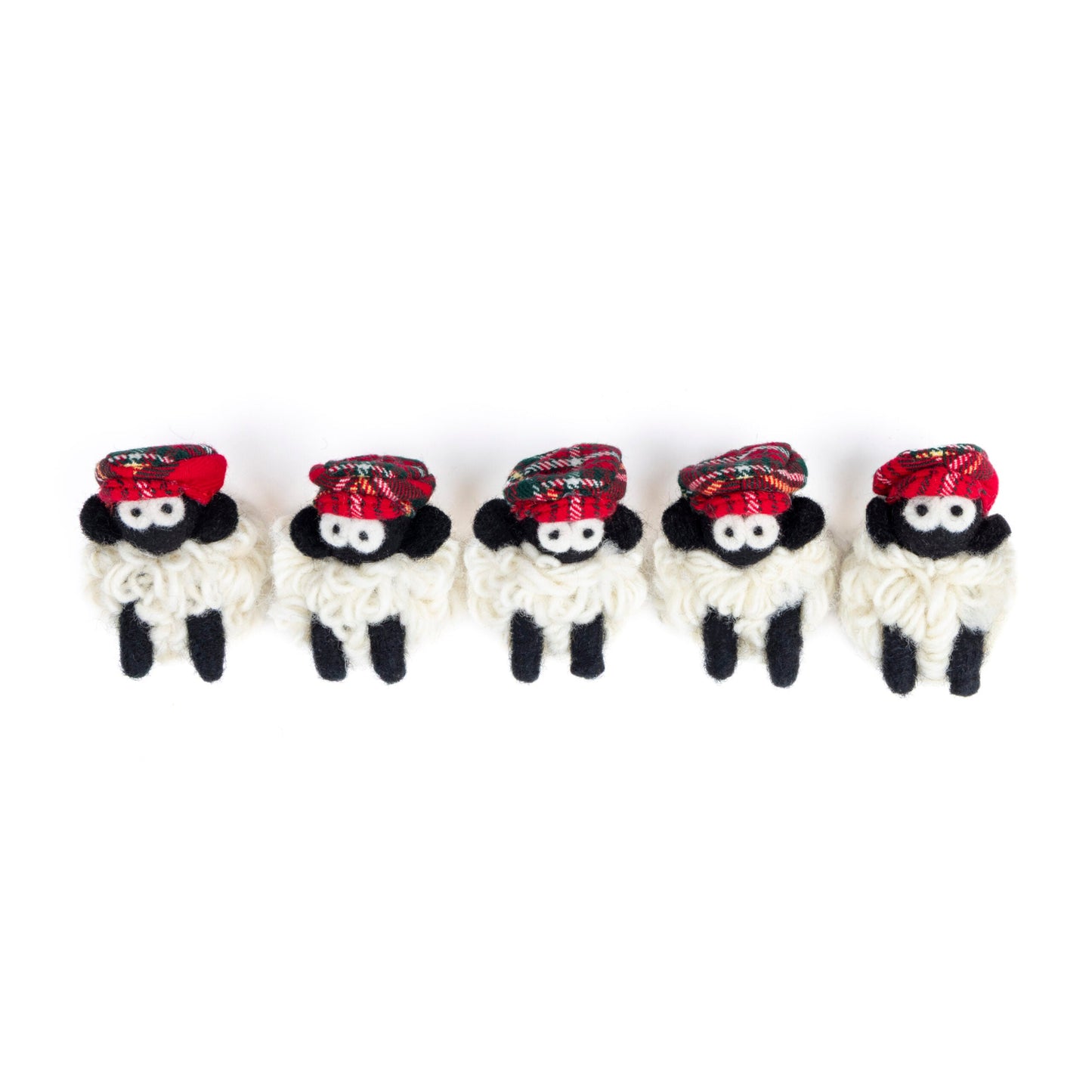 Five small knit sheep with red flat caps