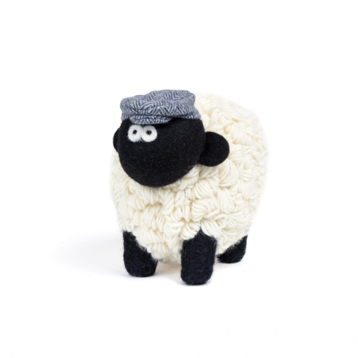 Extra large knit sheep wearing a blue flat cap