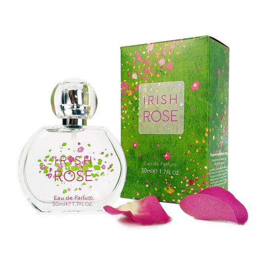 A clear perfume bottle with floral print next to a green floral perfume box. 