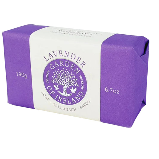 A bar of lavender shea butter soap with purple and white packaging