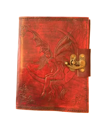 A red leather journal with an embossed fairy design and a metal lock closure.