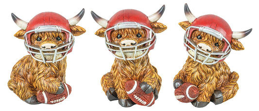 Three decorative Highland cow figurines wearing football helmets and holding footballs.