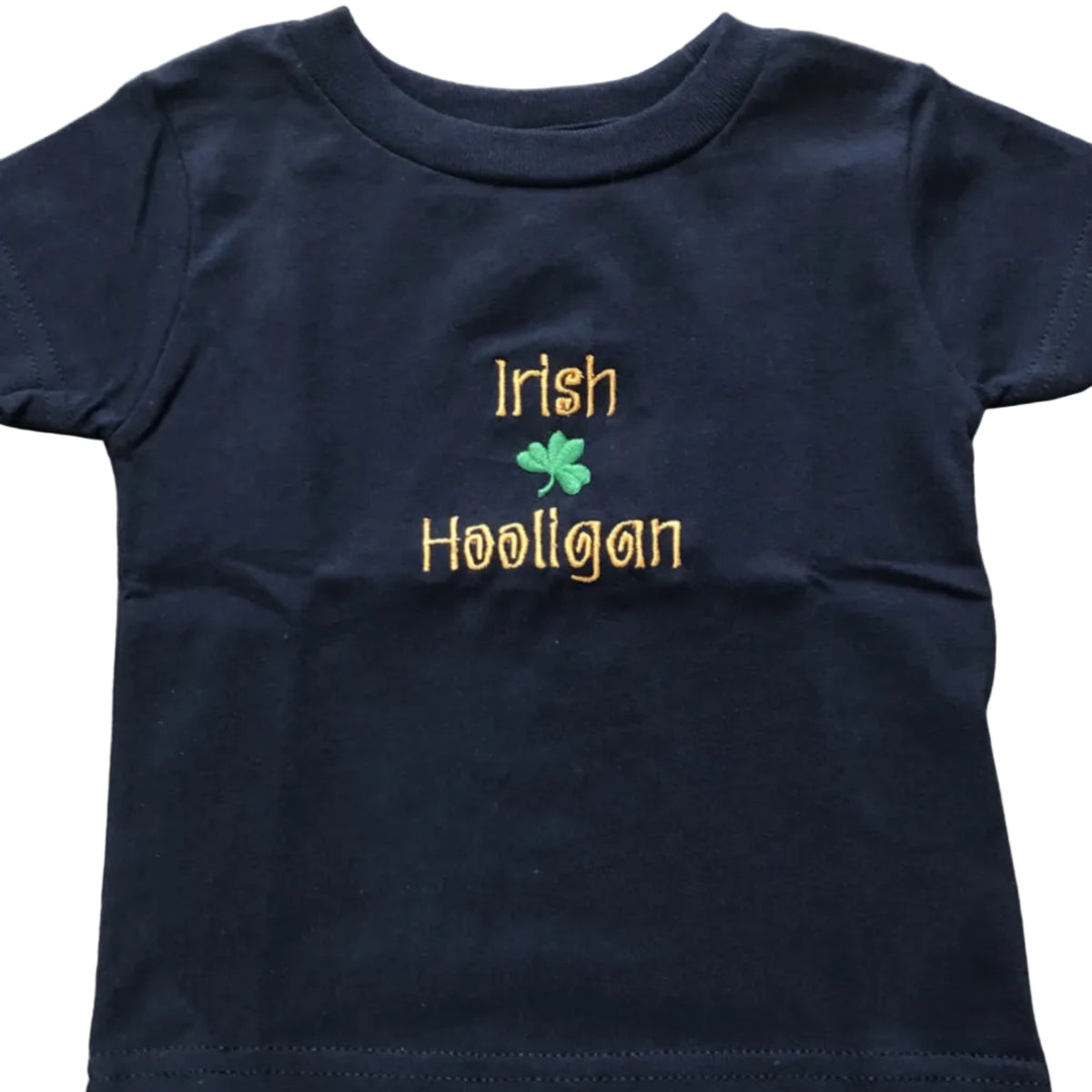 Navy blue t-shirt with 'Irish Hooligan' text and a green clover on a wooden surface