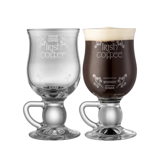 Two Irish coffee glasses with one filled with a layered drink on a white background