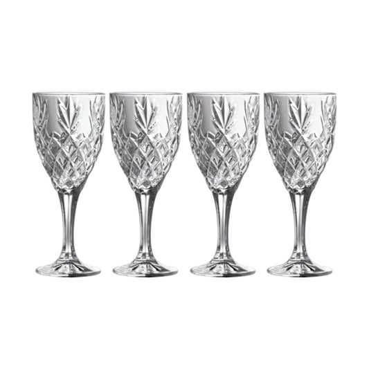 Four crystal wine glasses with cut patterns on a white background