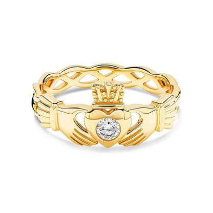 Gold claddagh ring with twisting band and a white diamond center on a white background.