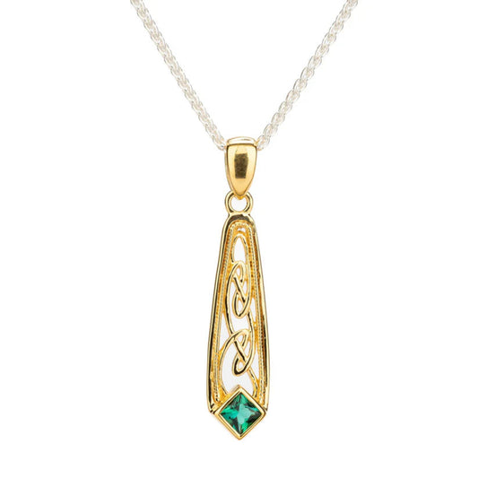 Gold pendant with green gemstone on a white background