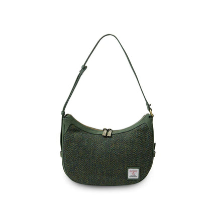 Green shoulder bag with a visible brand label on a white background