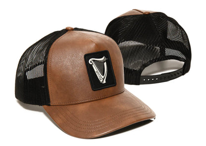 Brown leather trucker hat with black mesh back and Guinness Harp logo on a white background
