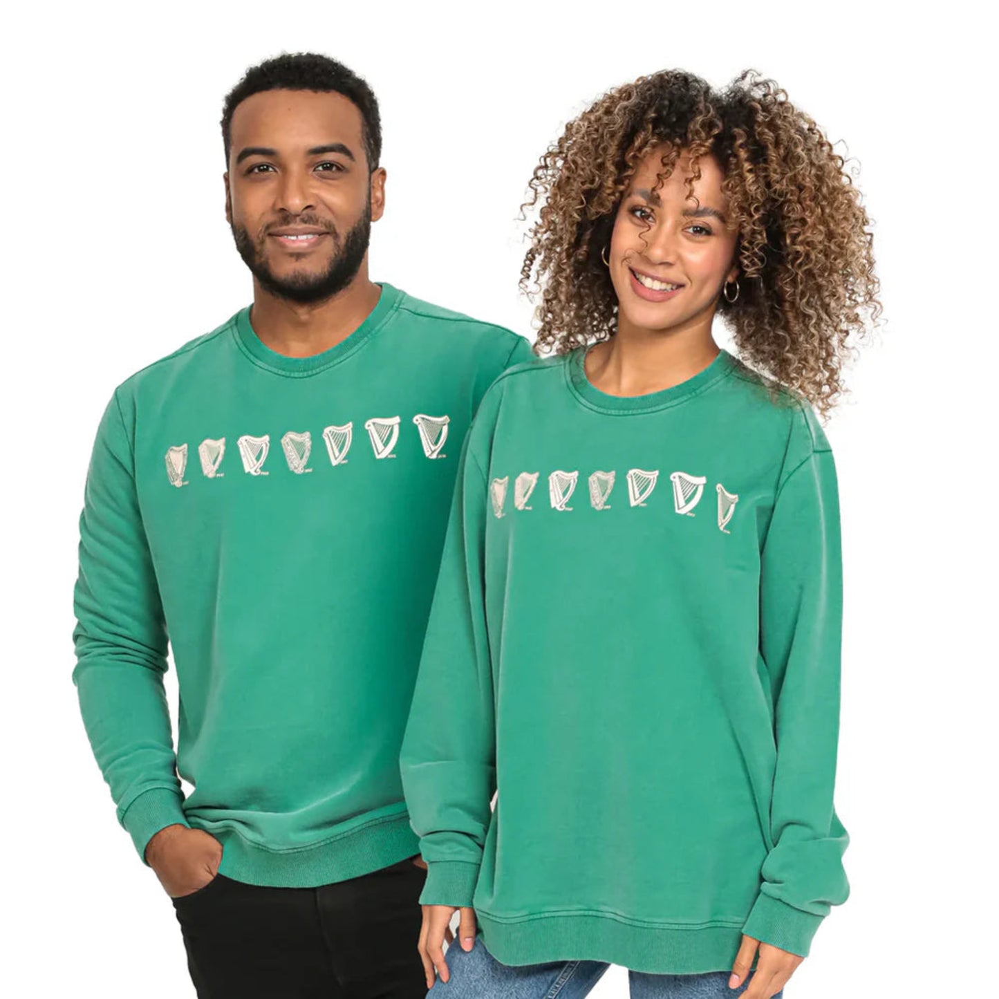 A man and a woman wearing green sweatshirts with white harp designs. 