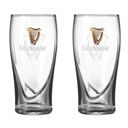 Two clear Guinness beer glasses with harp logos and Guinness written on the front. 