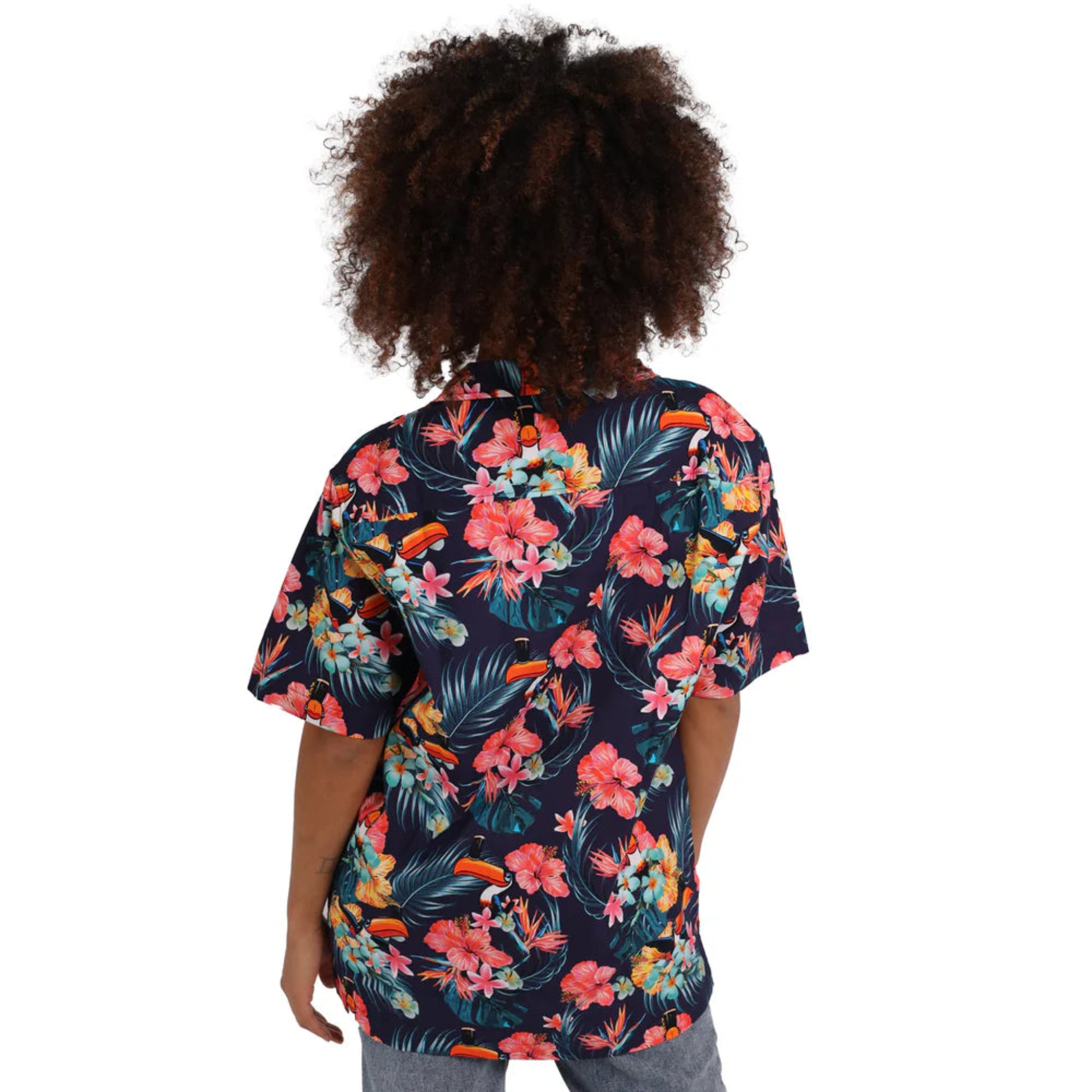 Woman facing away to show the back of a floral toucan patterned button-up.