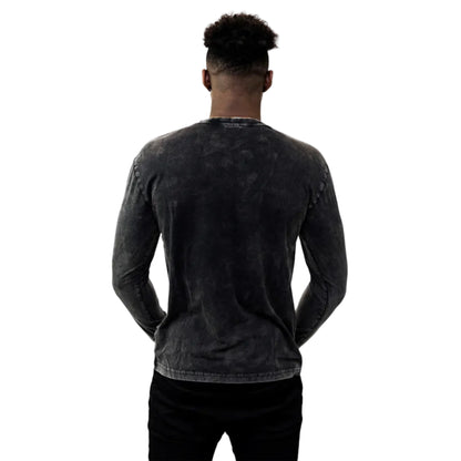 A man turned to show the back of his long-sleeved black shirt.