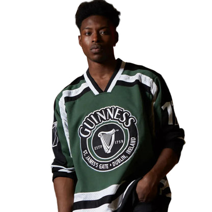 A man casually wearing a green Guinness hockey jersey.