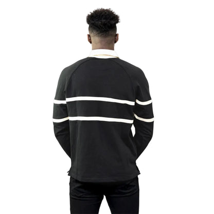 A man showing the back of a black rugby shirt with cream-colored stripes and a cream-colored collar.