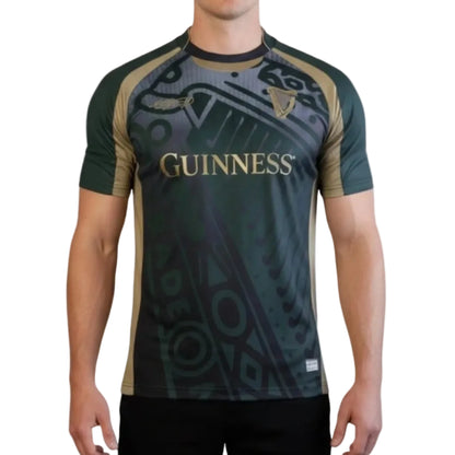 Man wearing a green, black, and gold soccer jersey with "Guinness" written across the chest. 