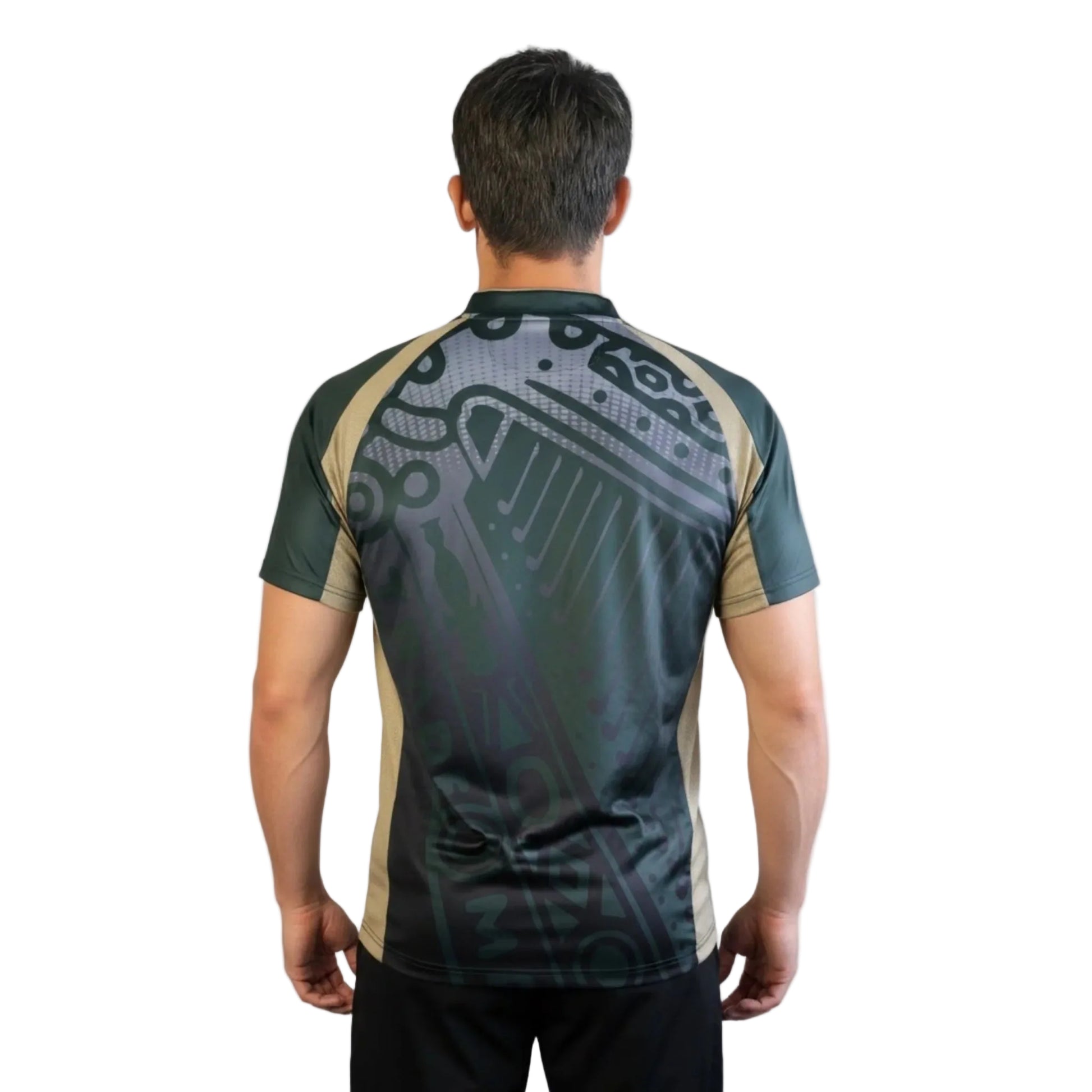Man showing the back of his green, gold, black, and grey patterned soccer jersey.