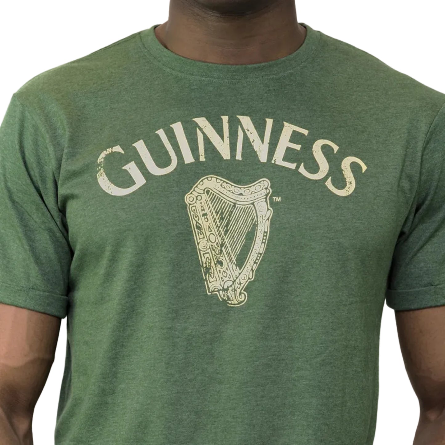 Close-up of a man wearing a green shirt with the word "Guinness" and a harp printed across the chest.