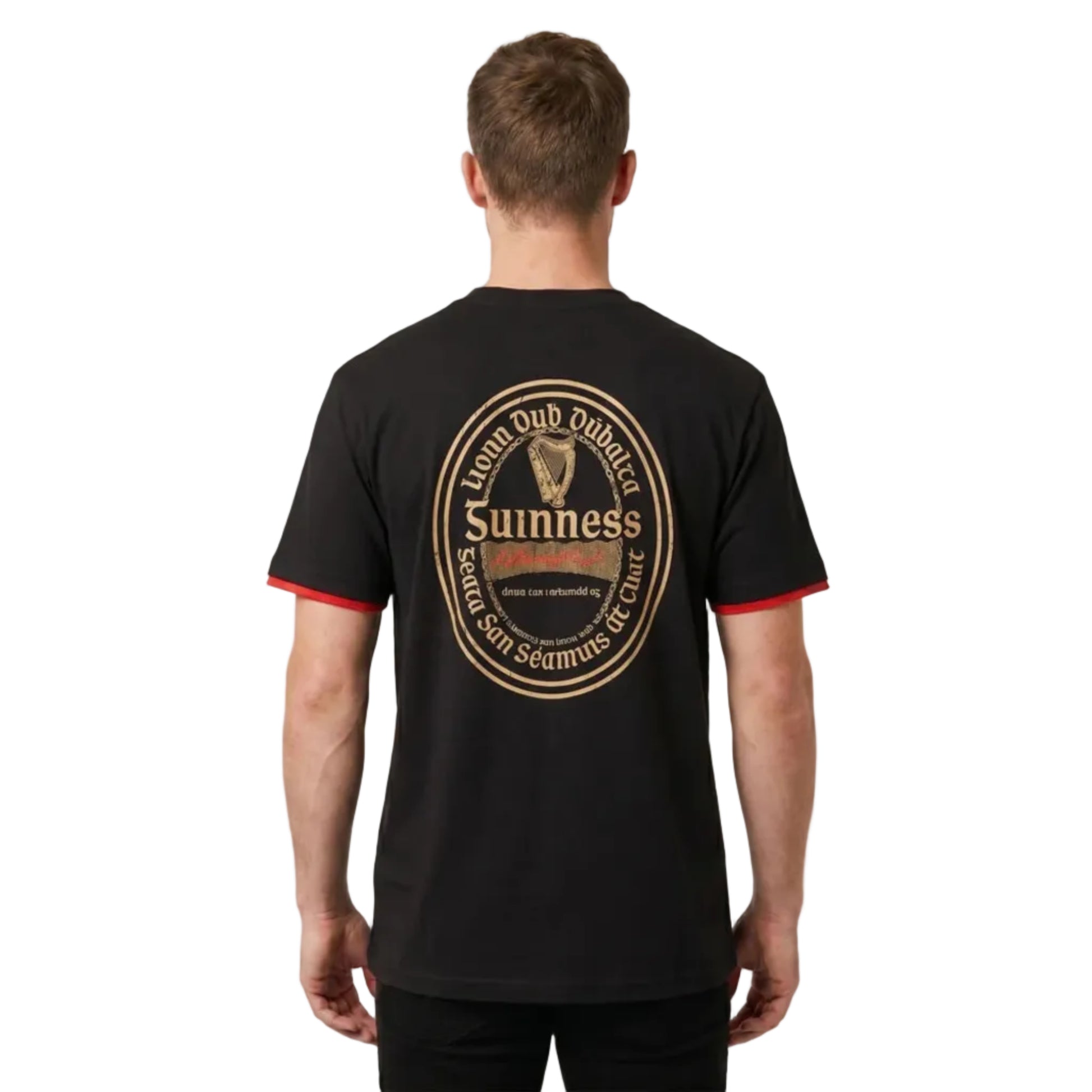 Man turned to show the back of his shirt. It has a large Guinness beer label written in Gaelic. 