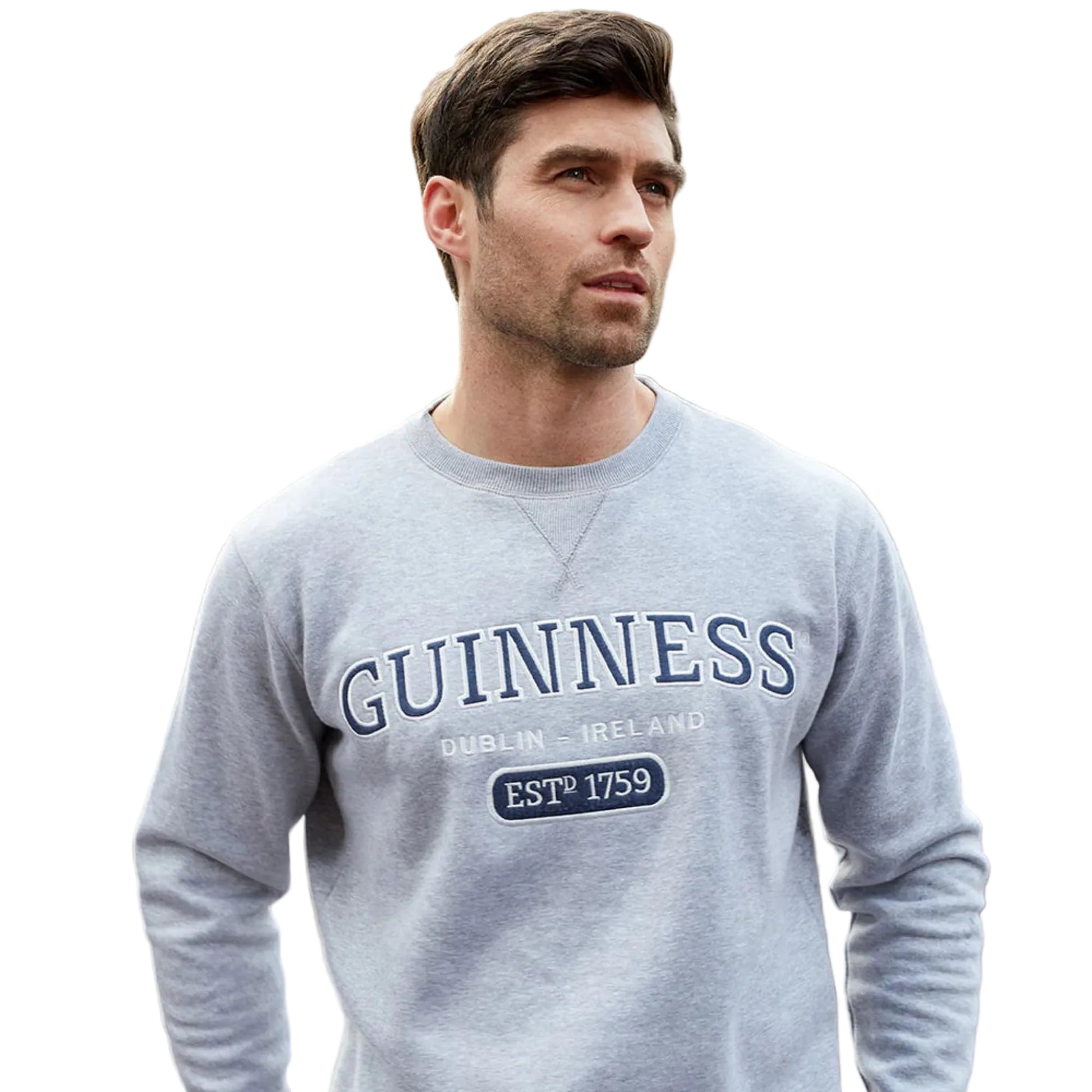 A man wearing a grey crew neck sweatshirt with "Guinness" embroidered across the chest.