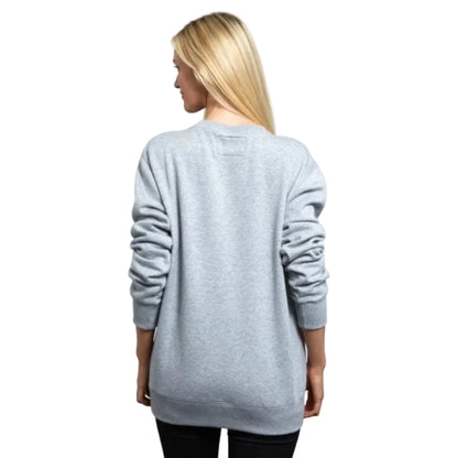 Back of a woman wearing a grey crewneck sweatshirt.