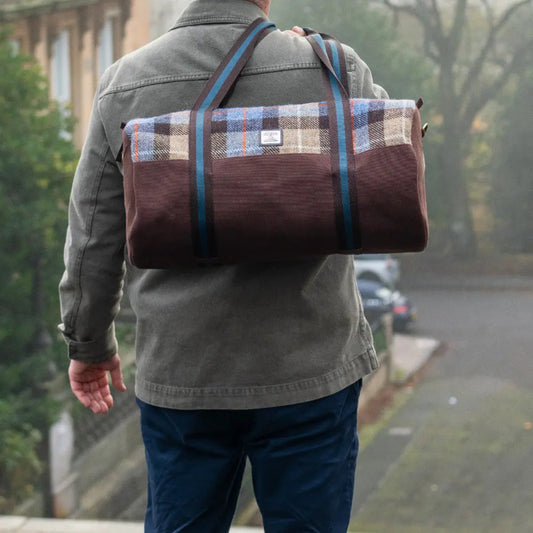 Person wearing a plaid duffel bag on a street