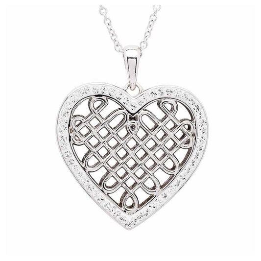 Silver heart-shaped pendant with intricate design on a white background