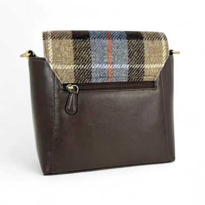 Brown leather handbag with plaid flap on a white background