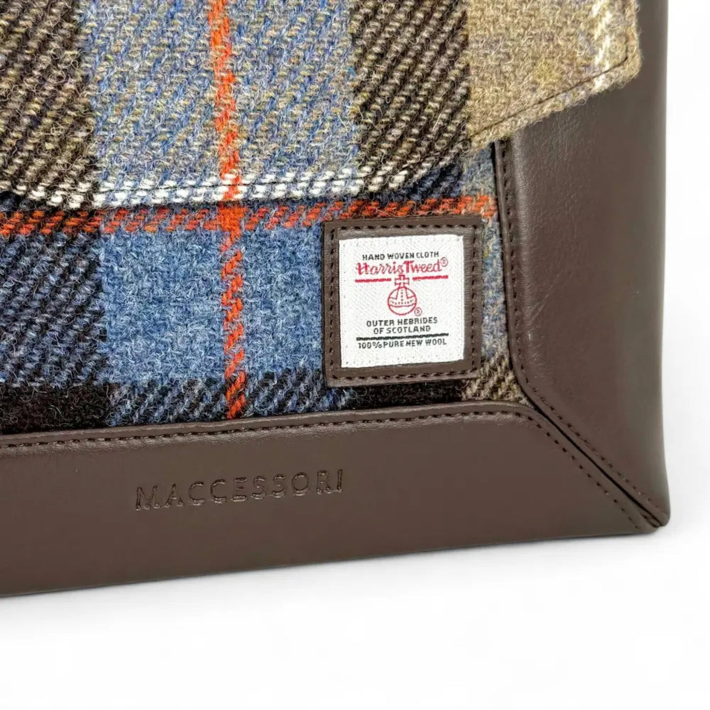 Close-up of a plaid fabric product with a label and 'Macclesfield' branding on a white background
