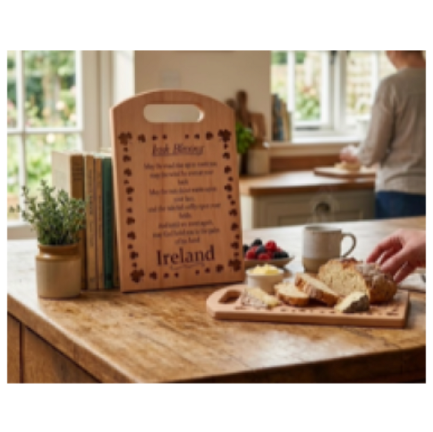 Wooden cutting board with engraved text on a kitchen counter with bread and coffee.