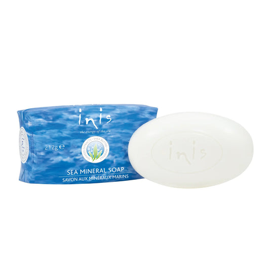 A bar of white inis soap next to a blue wave-patterned box
