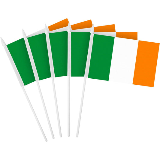 A collection of small Irish flag stick flags with green and orange rectangular banners on white sticks.