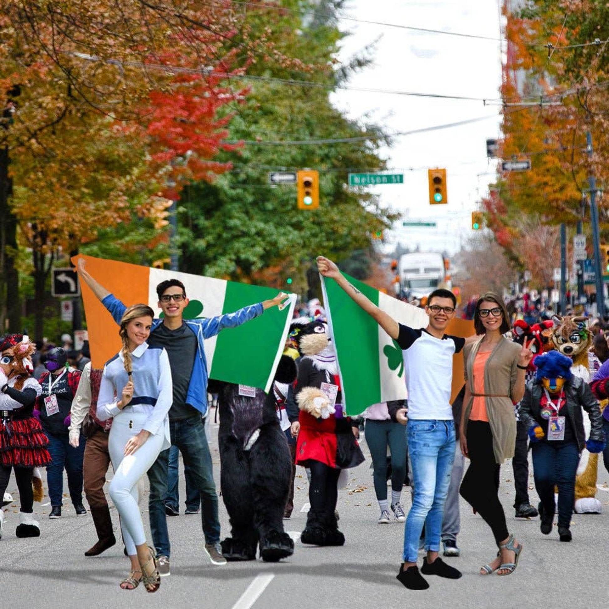 Two couples holding Irish clover flags at a festive outdoor event. 